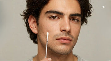 Man swabbing his cheek to understanding his skin microbiome